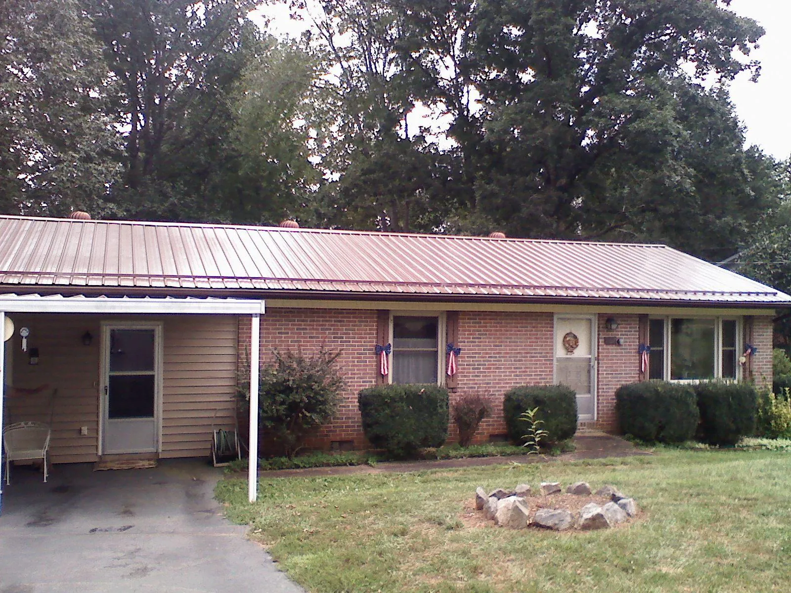 Bronze metal roof and carport on a brick ranch home — Roof Repair work by our crew in Fontana